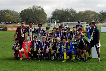 Tuzos Phoenix team on the field with championship medals